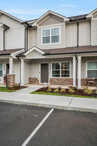 a front view of a house with a lots of and white umbrellas