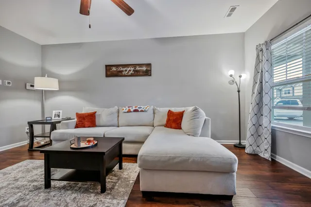 a living room with furniture and wooden floor