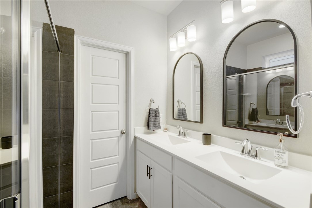 4405 Swift Path, Unit 17 Austin, TX 78741 - Photo 15 of 33 a bathroom with a double vanity sink and a mirror