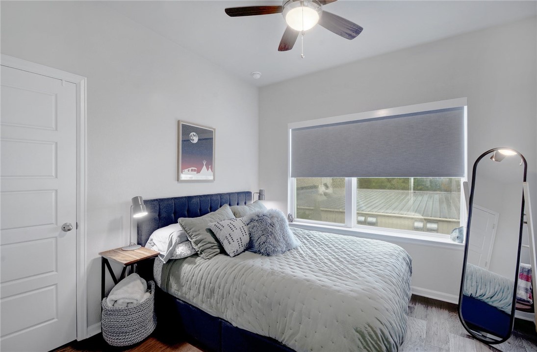4405 Swift Path, Unit 17 Austin, TX 78741 - Photo 17 of 33 a bedroom with a bed and a large window