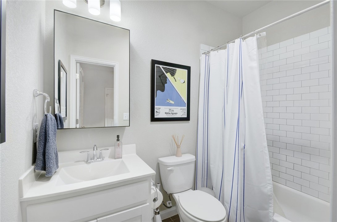 4405 Swift Path, Unit 17 Austin, TX 78741 - Photo 18 of 33 a bathroom with a toilet sink and mirror