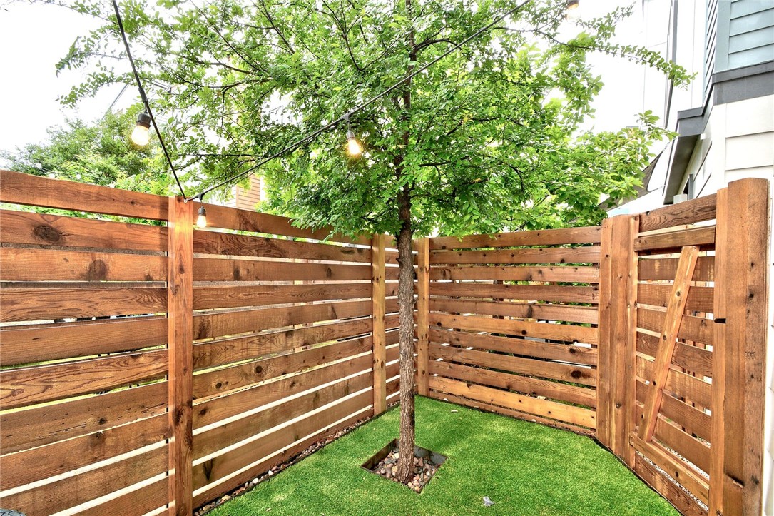 4405 Swift Path, Unit 17 Austin, TX 78741 - Photo 23 of 33 a view of a wooden fence and trees
