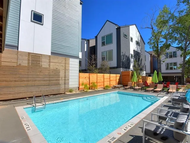 a view of a house with swimming pool in front of it