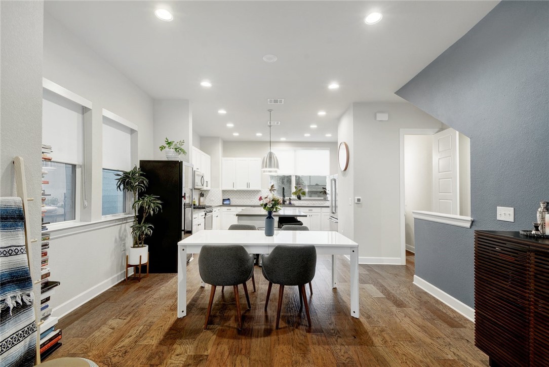 4405 Swift Path, Unit 17 Austin, TX 78741 - Photo 7 of 33 a kitchen with a dining table chairs refrigerator and microwave