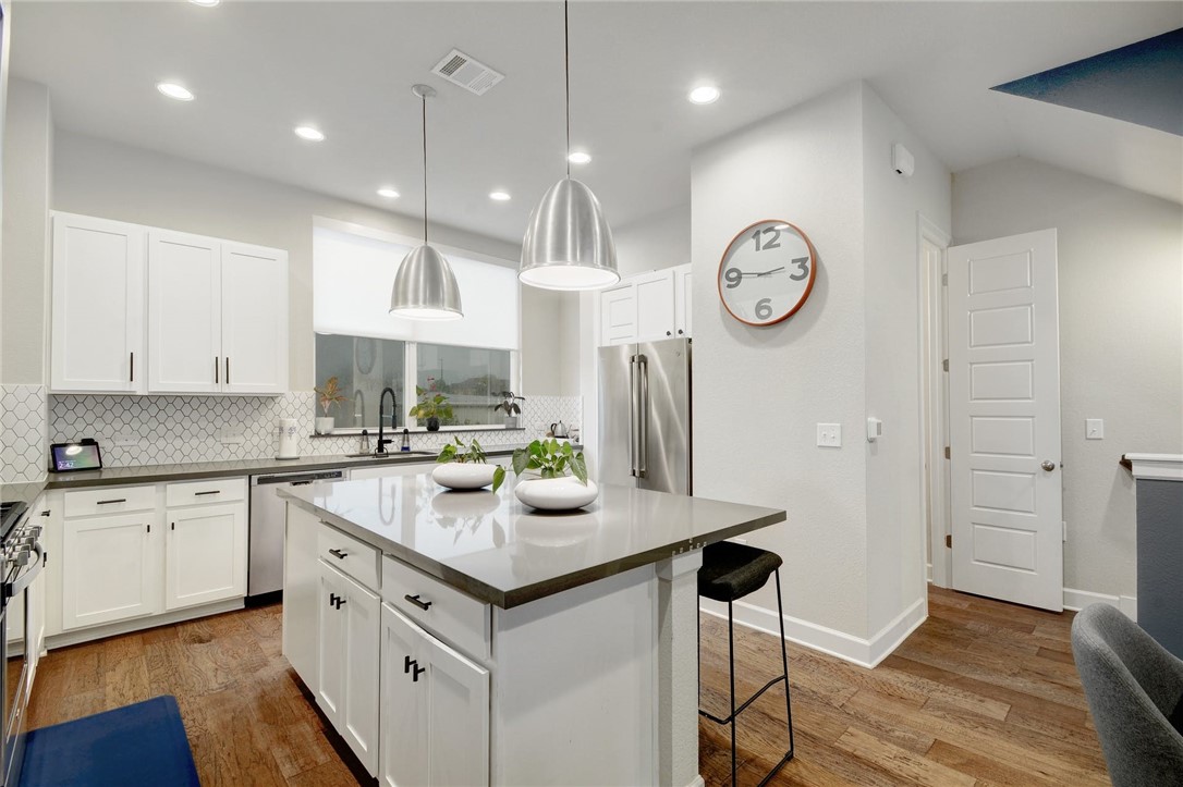 4405 Swift Path, Unit 17 Austin, TX 78741 - Photo 9 of 33 a kitchen with a refrigerator a sink and cabinets