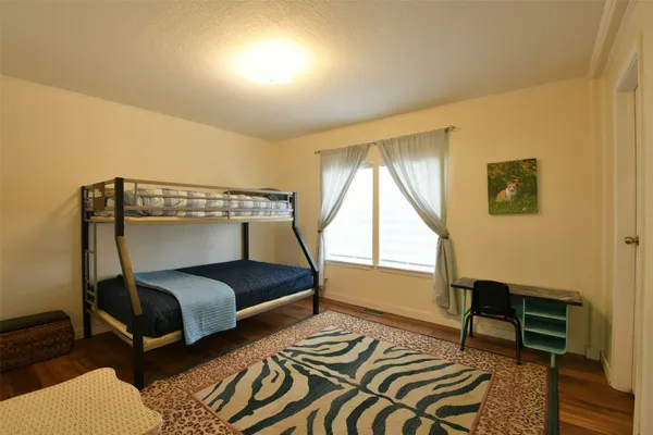 a dining room with furniture a chandelier and wooden floor