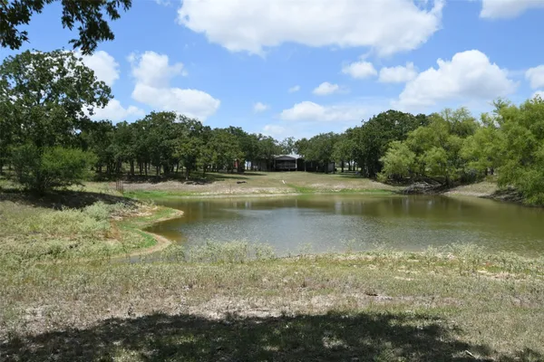 a view of a lake with houses in the back