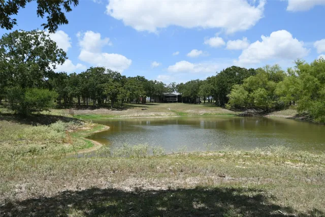 a view of a lake with houses in the back