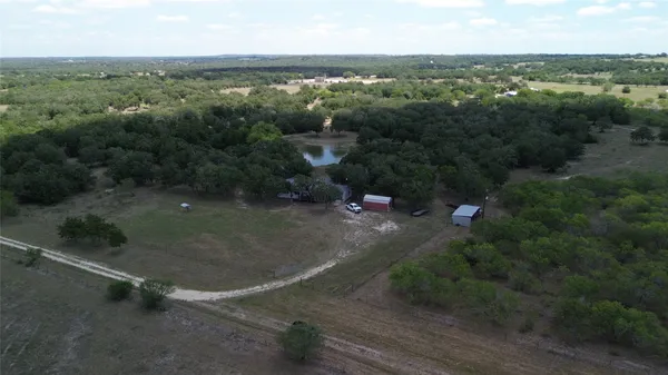 an aerial view of a forest with houses