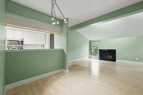a view of a kitchen with microwave and cabinets