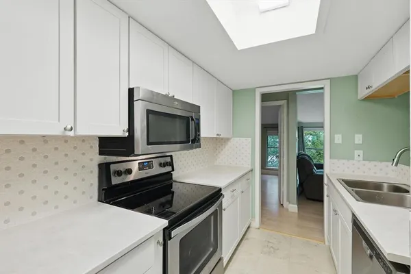 a kitchen that has a sink and a stove in it