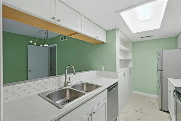 a bathroom with a sink and mirror
