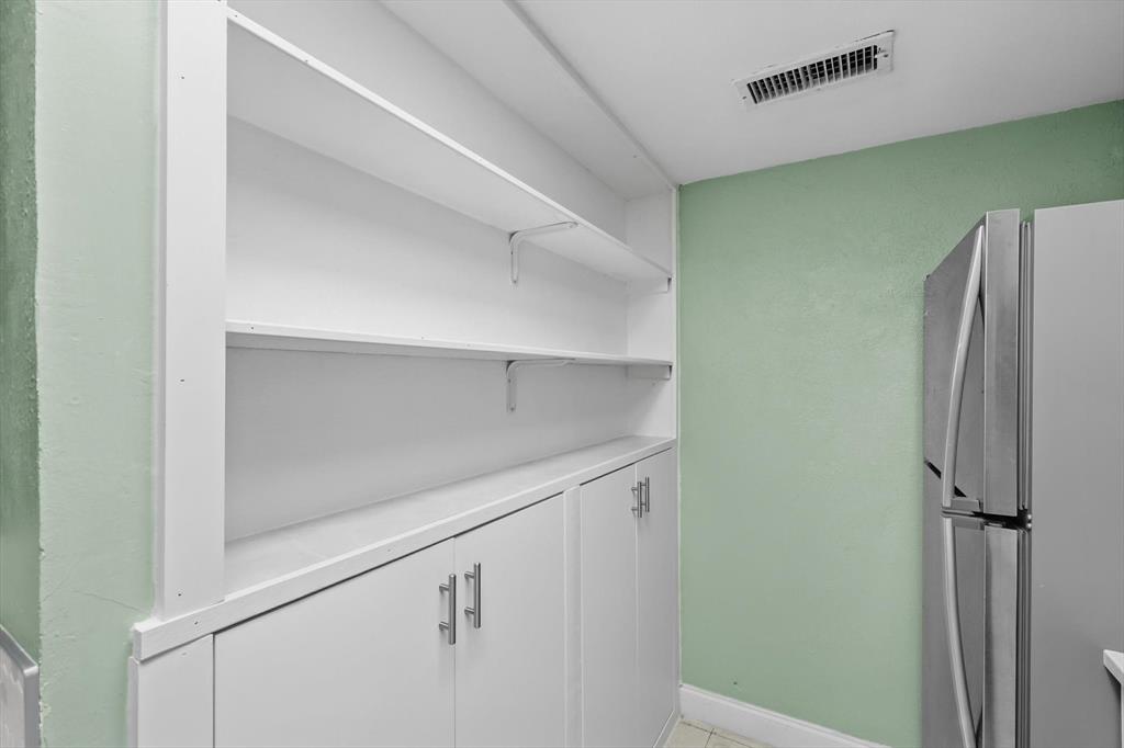 12824 Midway Road, Unit 2136 Dallas, TX 75244 - Photo 20 of 40 a view of cabinets and refrigerator
