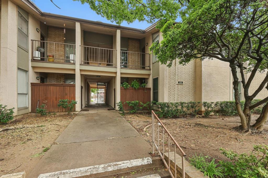 12824 Midway Road, Unit 2136 Dallas, TX 75244 - Photo 2 of 40 a front view of a house with a yard