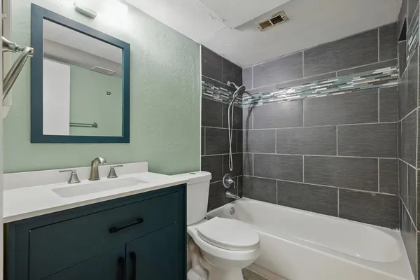 a bathroom with a sink mirror toilet and bathtub