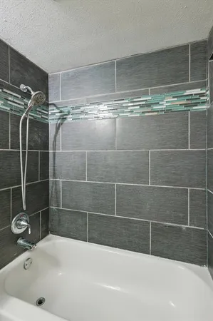 a bathroom with a bathtub and a shower
