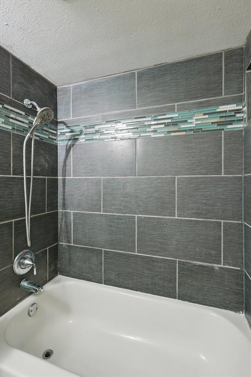 12824 Midway Road, Unit 2136 Dallas, TX 75244 - Photo 33 of 40 a bathroom with a bathtub and a shower