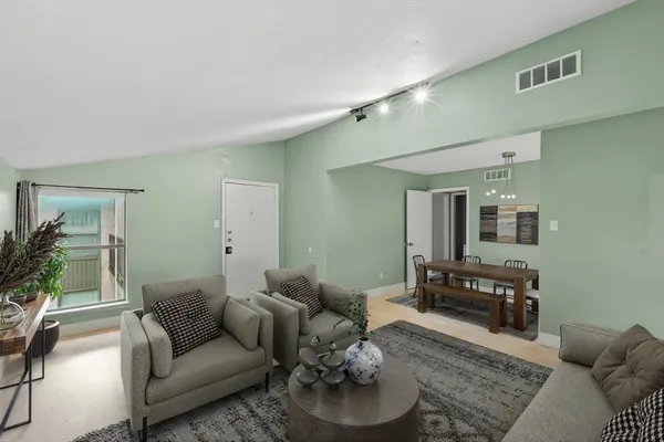 a living room with furniture and wooden floor