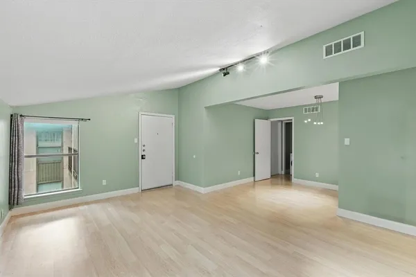 an empty room with windows and closet