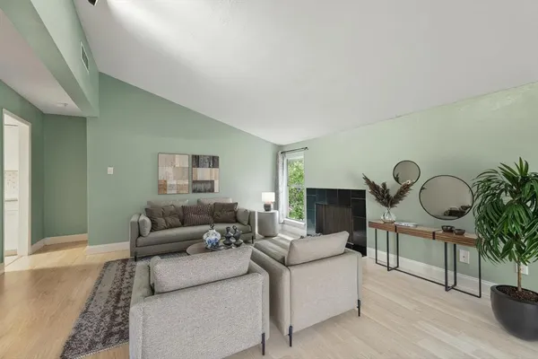 a living room with furniture and a fireplace