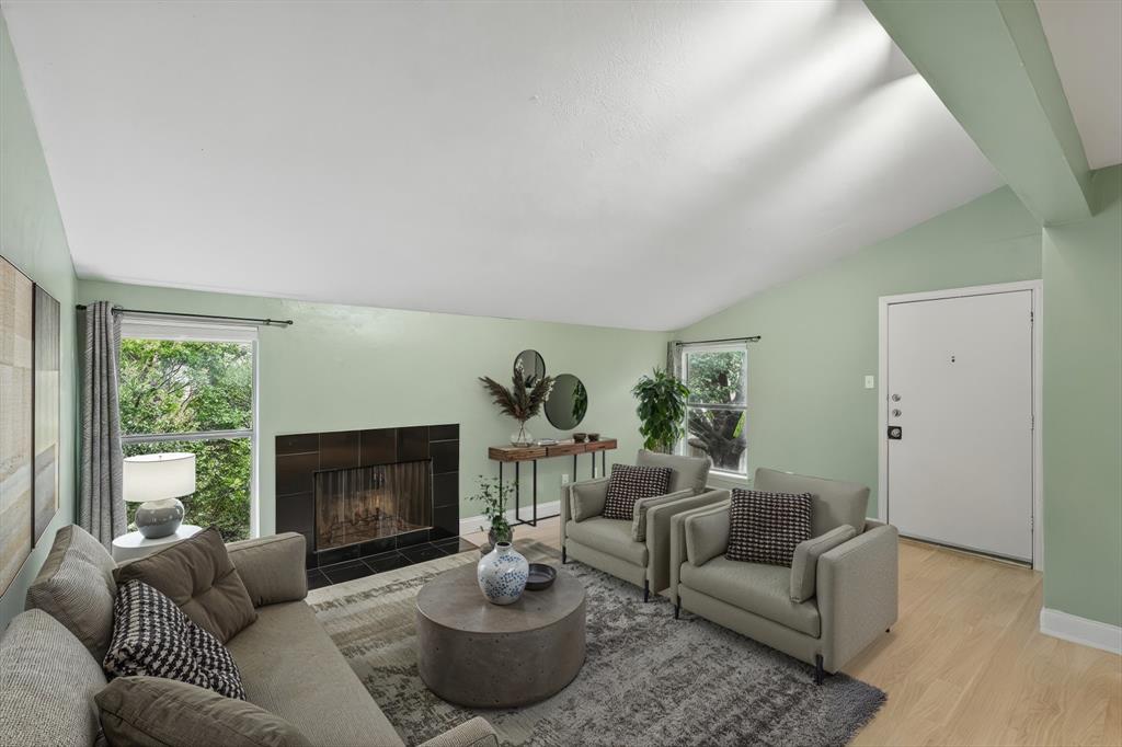 12824 Midway Road, Unit 2136 Dallas, TX 75244 - Photo 10 of 40 a living room with furniture a fireplace and a large window