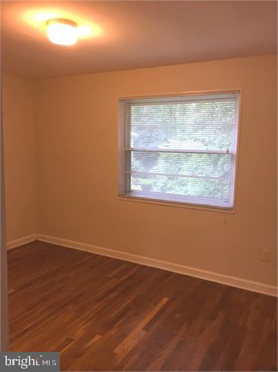 5319 Pooks Hill Road, Unit 1 Bethesda, MD 20814 - Photo 18 of 18 an empty room with wooden floor and windows