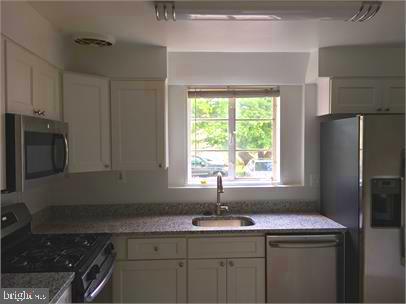 5319 Pooks Hill Road, Unit 1 Bethesda, MD 20814 - Photo 4 of 18 a kitchen with a sink stove and refrigerator