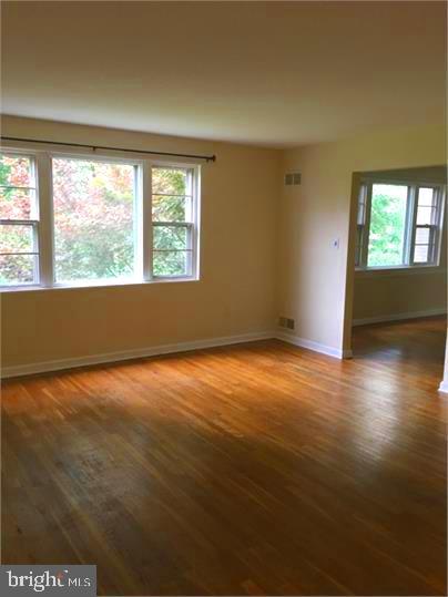 5319 Pooks Hill Road, Unit 1 Bethesda, MD 20814 - Photo 8 of 18 an empty room with wooden floor and windows