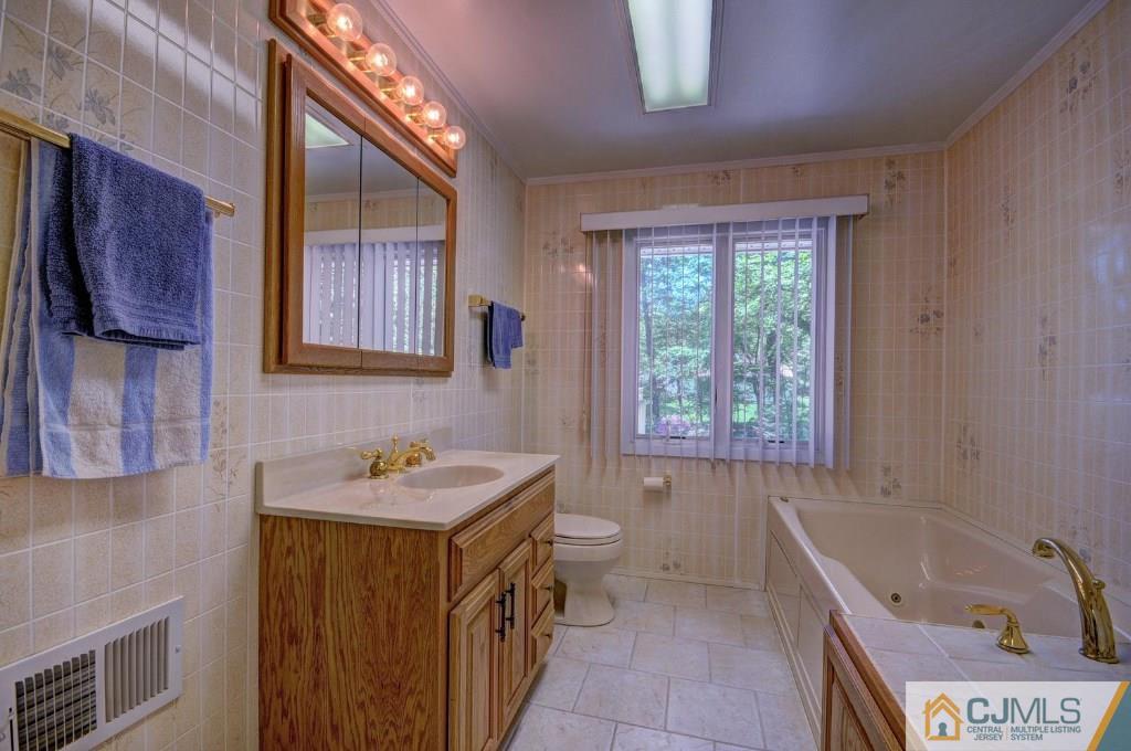 5 Timber Road East Brunswick, NJ 08816 - Photo 13 of 25 a bathroom with a sink and a bathtub