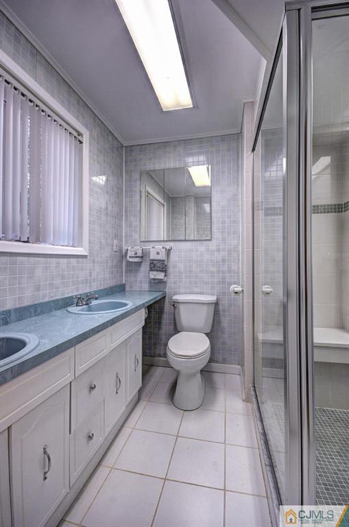 5 Timber Road East Brunswick, NJ 08816 - Photo 14 of 25 a bathroom with a granite countertop toilet sink and mirror
