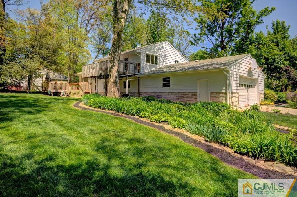 5 Timber Road East Brunswick, NJ 08816 - Photo 24 of 25 a front view of a house with a yard and trees