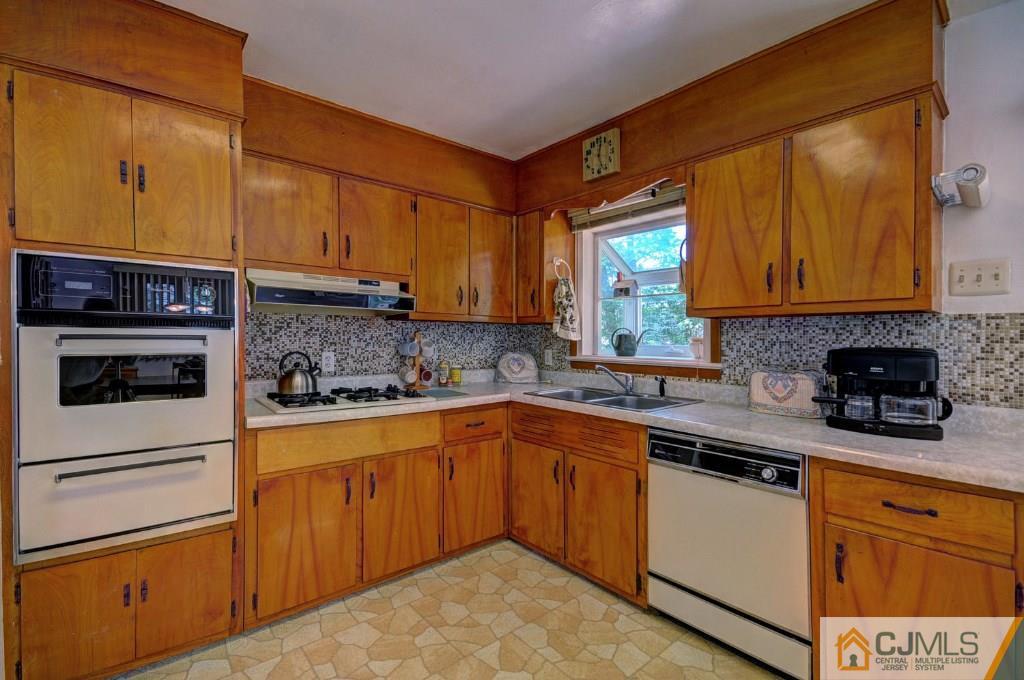 5 Timber Road East Brunswick, NJ 08816 - Photo 5 of 25 a kitchen with stainless steel appliances granite countertop wooden cabinets and a stove top oven