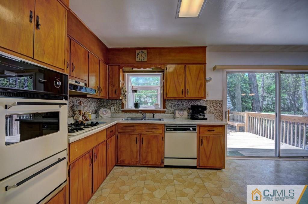 5 Timber Road East Brunswick, NJ 08816 - Photo 6 of 25 a kitchen with stainless steel appliances granite countertop a stove a sink dishwasher and a microwave oven with cabinets