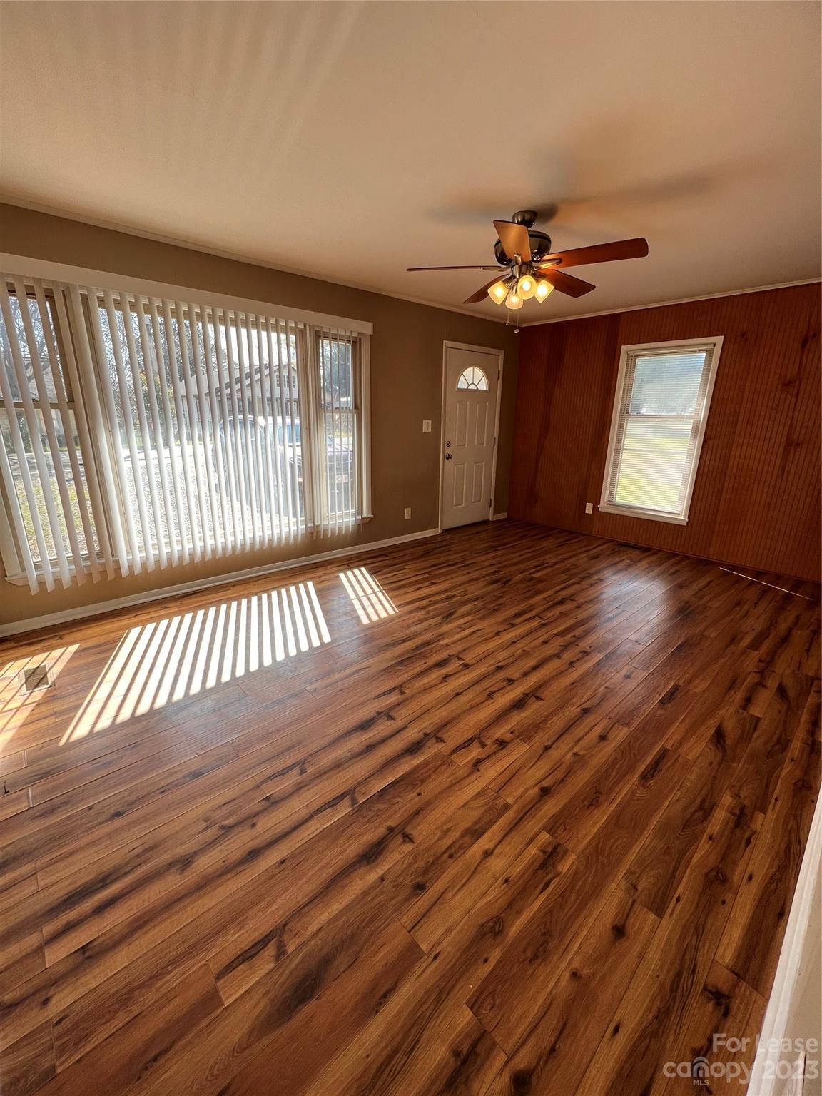 2213 Acme Road Belmont, NC 28012 - Photo 2 of 8 a view of an empty room with wooden floor and a window