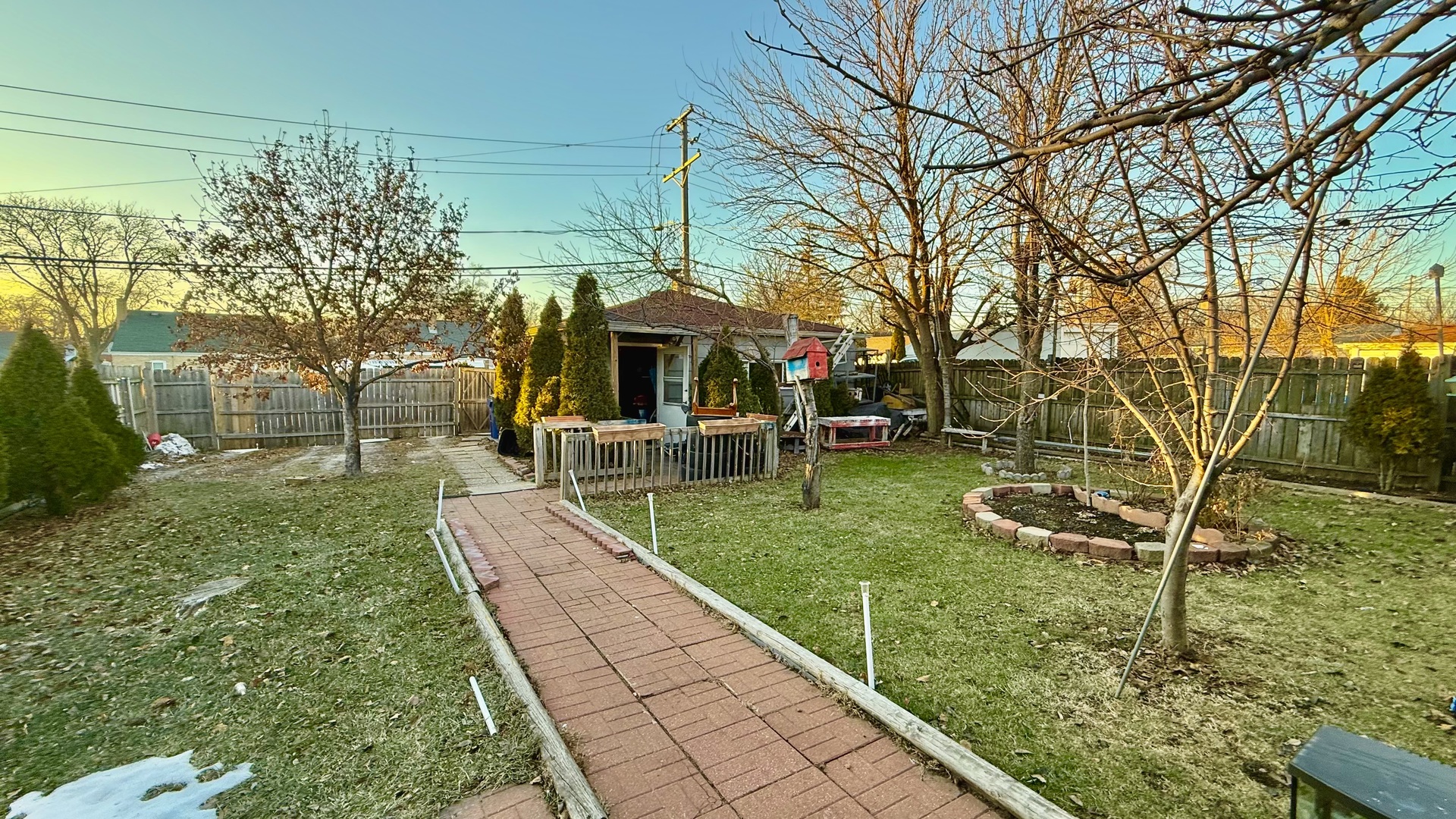 128 North York Road Bensenville, IL 60106 - Photo 16 of 19 a view of a backyard with table and chairs under an umbrella
