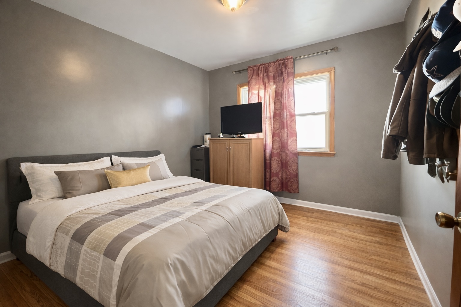 128 North York Road Bensenville, IL 60106 - Photo 6 of 19 a bedroom with a bed and flat tv screen on the dresser