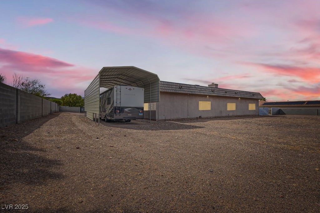 647 Foxhall Road Henderson, NV 89002 - Photo 56 of 82 View of outdoor structure featuring dirt driveway, a detached carport, and fence