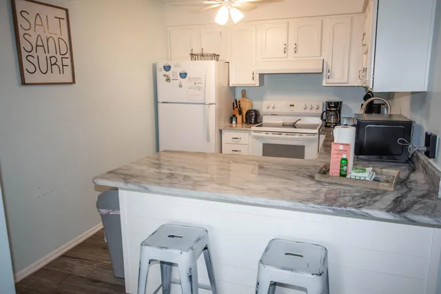 a kitchen with a refrigerator a stove a microwave and cabinets