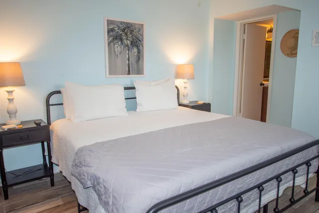 a bedroom with a bed and a lamp on table