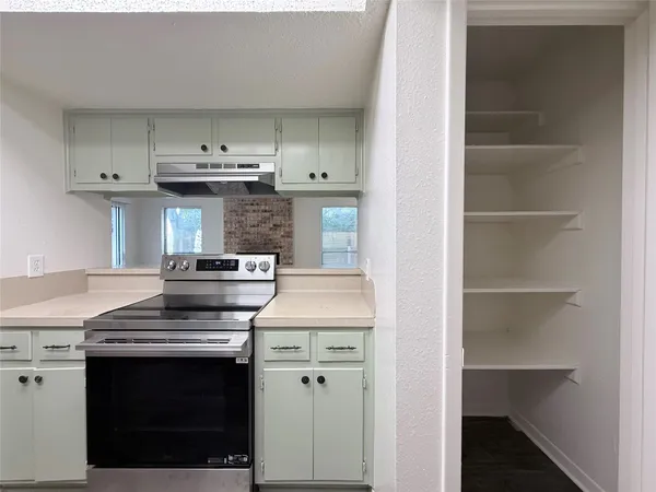 a kitchen with a sink a refrigerator and cabinets