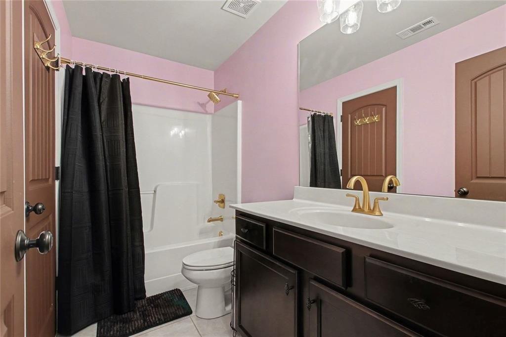 3499 In Bloom Way Auburn, GA 30011 - Photo 14 of 30 a bathroom with a sink a toilet a mirror and shower