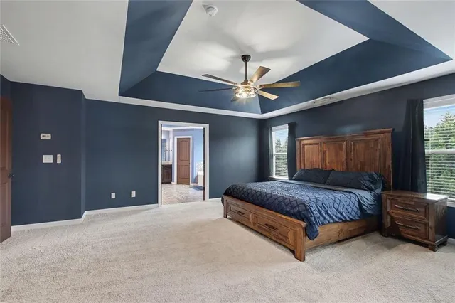 a living room with furniture and a ceiling fan