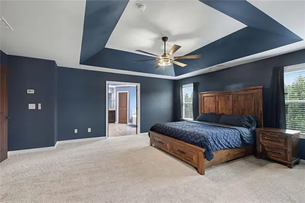 a living room with furniture and a ceiling fan