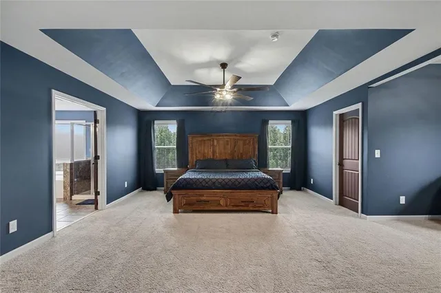 a bedroom with a bed and a ceiling fan