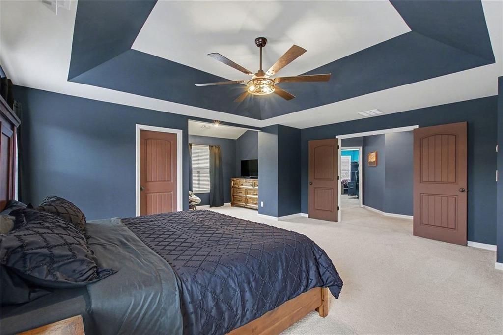 3499 In Bloom Way Auburn, GA 30011 - Photo 17 of 30 a bedroom with a bed and a ceiling fan