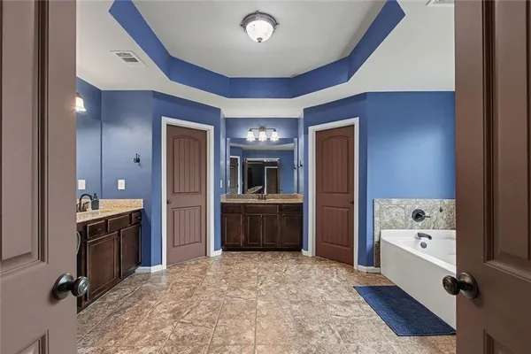 a large bathroom with a sink and a mirror