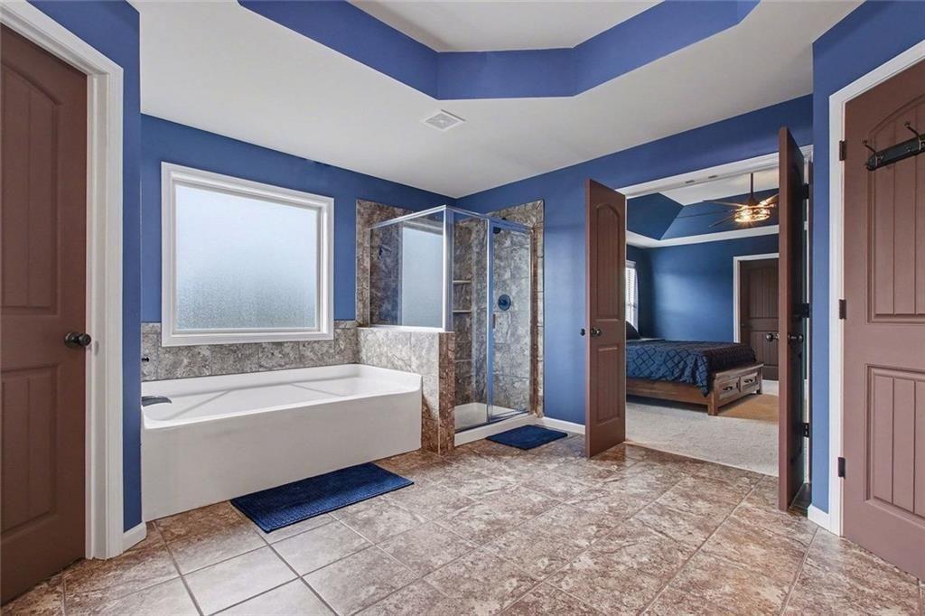 3499 In Bloom Way Auburn, GA 30011 - Photo 20 of 30 a bathroom with a bathtub and a shower