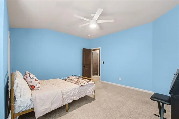 a bedroom with a bed and a ceiling fan