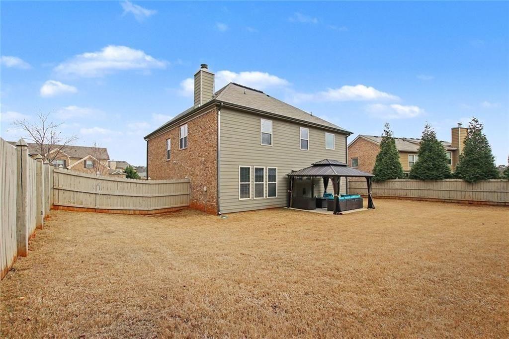 3499 In Bloom Way Auburn, GA 30011 - Photo 29 of 30 a view of a house with backyard and sitting area