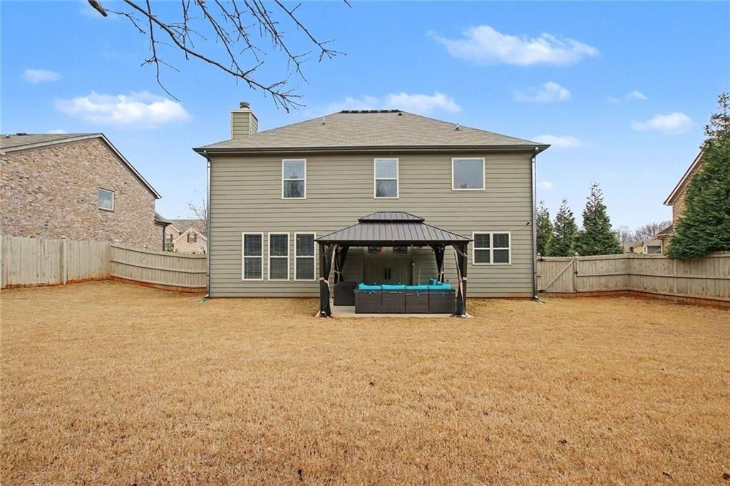 3499 In Bloom Way Auburn, GA 30011 - Photo 30 of 30 a view of a house with a backyard